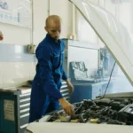 Mechanic inspecting a car engine in a workshop