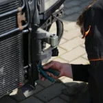 Mechanic inspecting a car radiator and cooling system