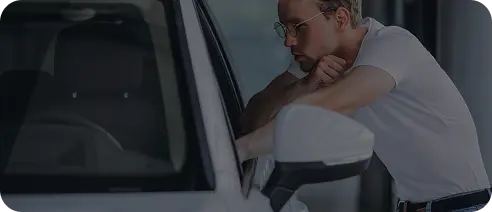 Driver leaning out of a car window