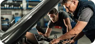 Mobile mechanics working on a car engine