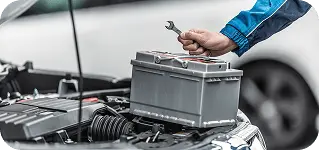 Mechanic replacing a car battery